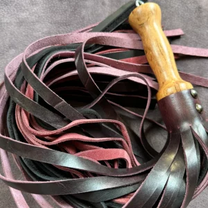 Gorgeous Mulberry pull-up, supple black leatherand plum coloured suede flogger with hand turned handle