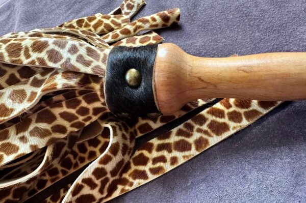 Giraffe print hair on calf hide and cowhide flogger with hand-turned handle. - Image 3