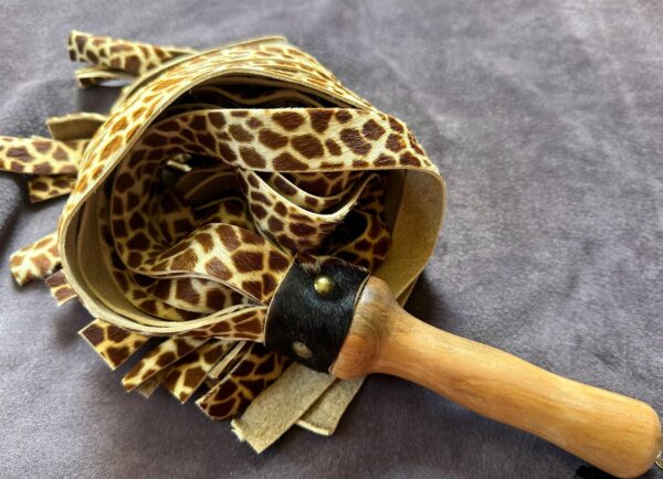 Giraffe print hair on calf hide and cowhide flogger with hand-turned handle. - Image 6