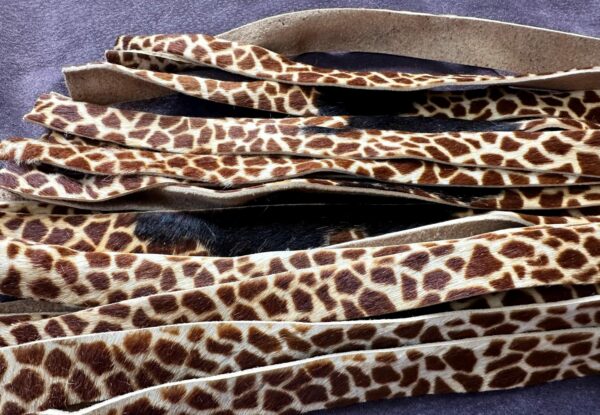 Giraffe print hair on calf hide and cowhide flogger with hand-turned handle. - Image 5