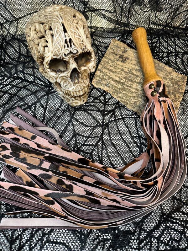 Pink hair on leopard hide with dusky mauve leather flogger with hand turned handle