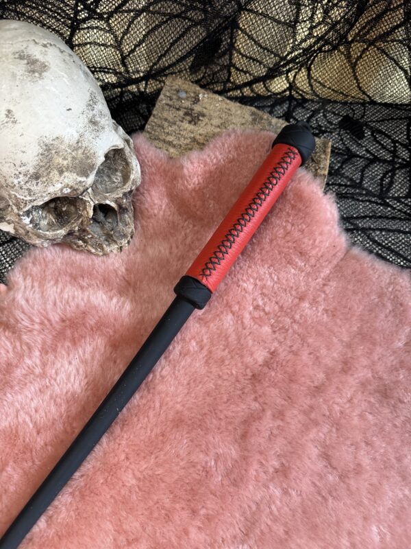 Rubber Whip with red leather wrapped handle and black stitching